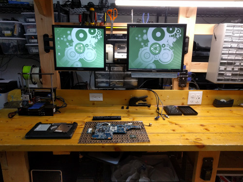 The keyboard/mouse tray can slide sideways along the workbench, and also rotate all the way underneath.